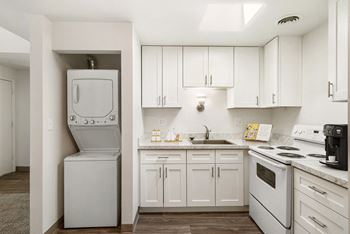 A white kitchen with white appliances and white cabinets